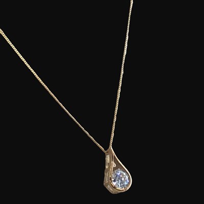 Lot 1248 - A 9ct gold teardrop shape CZ pendant and chain,...