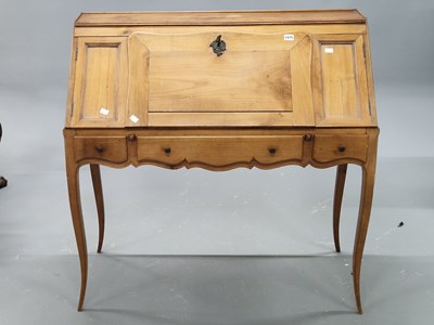 Lot 1475 - A French walnut bureau standing on slender...