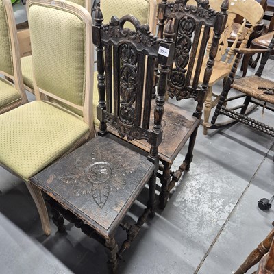 Lot 354a - A pair of antique carved oak chairs