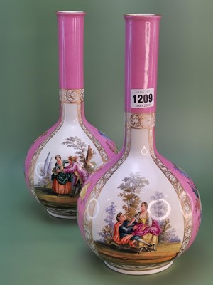 Lot 1209 - A pair of Dresden pink ground bottle vases...