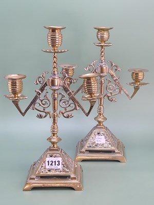 Lot 1213 - A pair of Victorian Neogothic brass candelabra,...