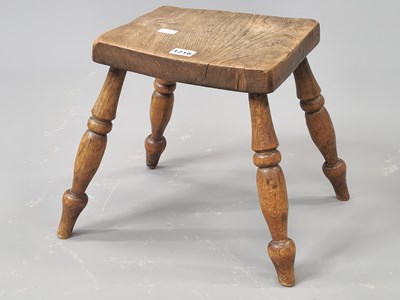 Lot 1216 - A 19th century oak stool with a squared seat...