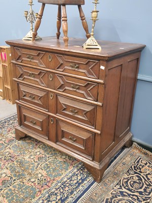 Lot 1235 - An early 18th century oak chest of four graded...