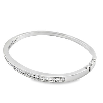 Lot 1074 - A hallmarked platinum bangle set with round...