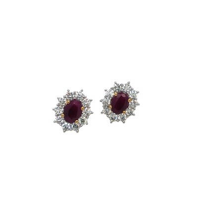 Lot 1093 - A pair of 9ct yellow and white gold oval ruby...