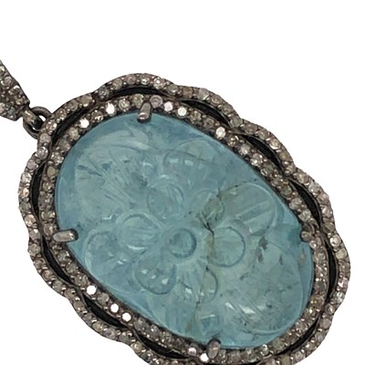 Lot 1094 - A large silver pendant set with an oval carved...