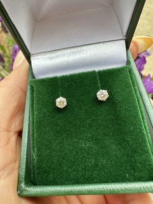 Lot 1072 - A pair of platinum round brilliant cut diamond...