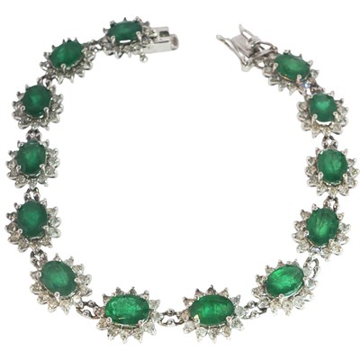 Lot 1010 - A white gold 18ct hallmarked gold emerald and...