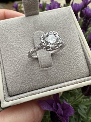 Lot 1013 - A hallmarked platinum diamond set halo ring...