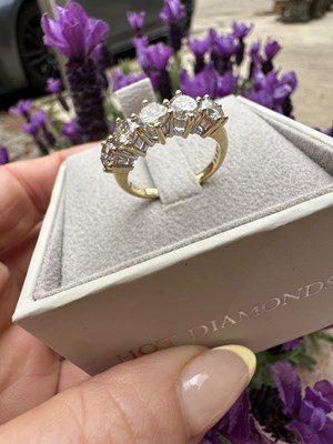 Lot 1014 - An 18ct hallmarked gold five-stone diamond...