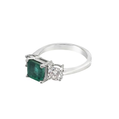 Lot 1017 - An 18ct white gold hallmarked emerald and...
