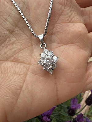 Lot 1031 - Floral diamond cluster pendant, set with round...
