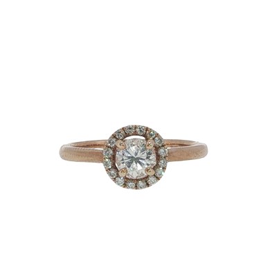 Lot 1037 - A rose gold diamond halo ring; the principal...