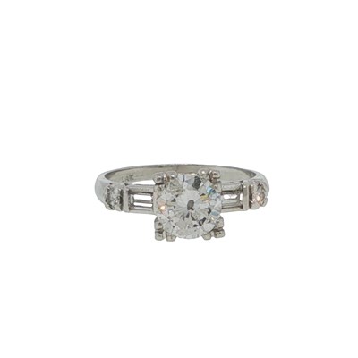 Lot 1040 - A modified brilliant cut diamond solitaire...