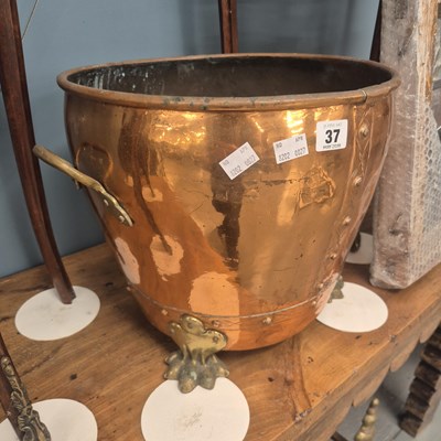 Lot 37 - A small copper coal bucket on brass paw feet