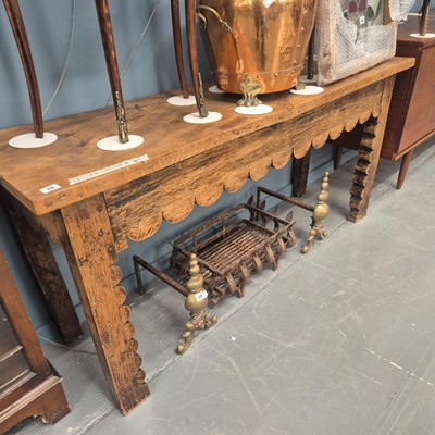 Lot 38 - A rustic hardwood hall table with wavy freize...