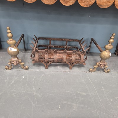 Lot 39 - An iron fire grate with brass fire dogs and a...