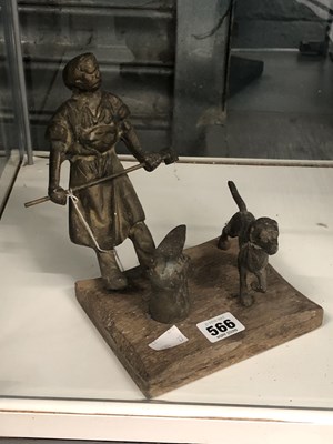 Lot 566 - A cast metal blacksmith figure hammering an...