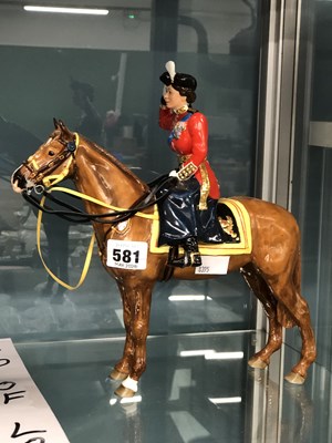 Lot 581 - A figurine of Queen Elizabeth II mounted on a...
