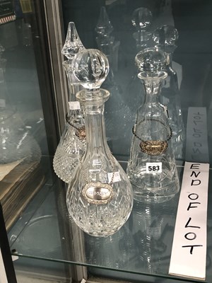 Lot 583 - Three glass decanters, complete with stoppers,...