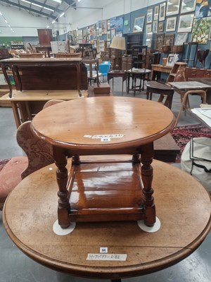 Lot 93 - A round oak occasional table with a square...