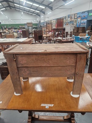 Lot 111 - An antique primitive carved oak chest showing...