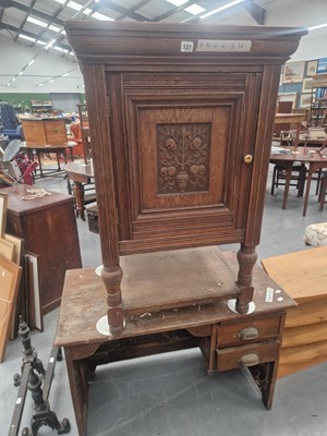 Lot 121 - An Edwardian oak music cabinet, the carved...