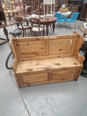Lot 127 - A vintage panelback winged pine box settle H...