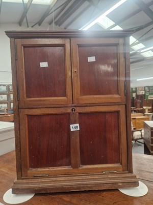 Lot 140 - A small vintage cabinet with a two door upper...