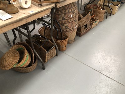 Lot 802 - A large collection of wicker and woven baskets,...