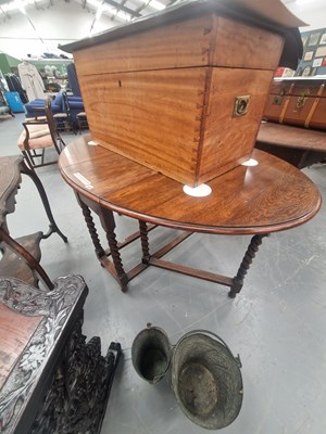 Lot 165 - A 20th century oval oak gateleg dining table...