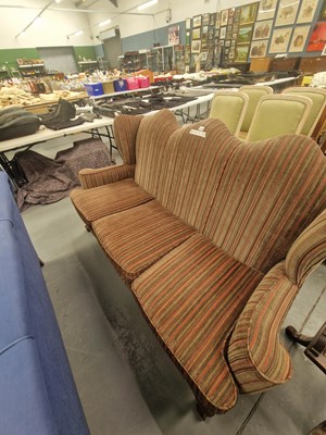 Lot 210 - An early 20th century camel back wing sofa...