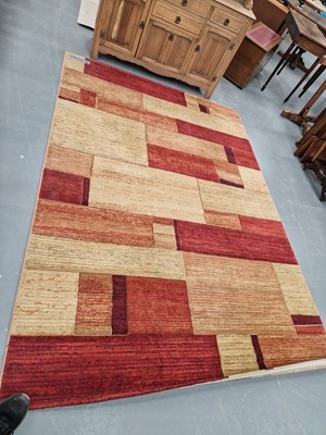 Lot 1398 - A machine-made carpet of contemporary design...