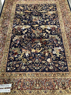 Lot 1403 - A machine made rug of Persian hunting design...