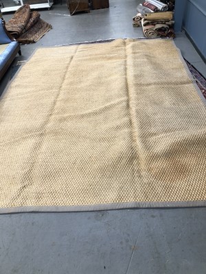 Lot 1417 - A contemporary carpet of natural fibre 397 ×...