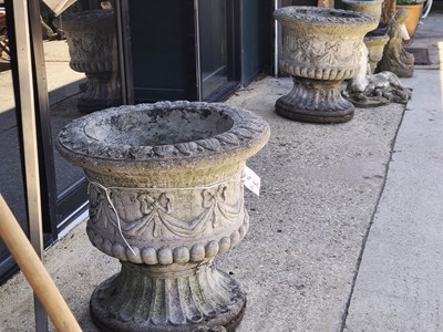 Lot 445 - A pair of cast concrete urns with stands