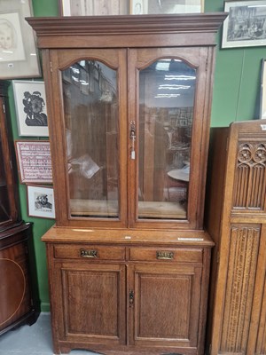 Lot 244 - An early 20th century oak glazed bookcase...