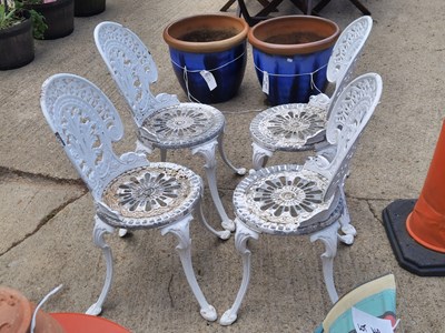 Lot 462 - A set of four cast aluminium garden chairs...