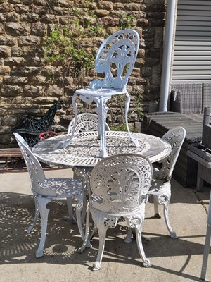 Lot 497 - A cast aluminium table with five chairs