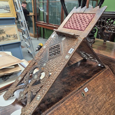 Lot 298 - A carved koran stand and an occasional table