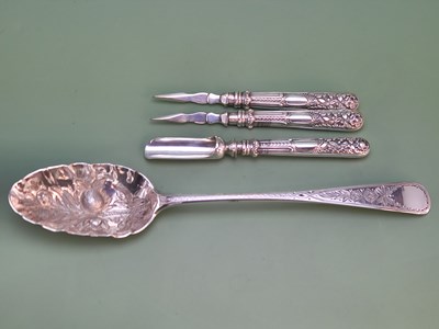Lot 1191 - A Victorian silver berry spoon, two silver...