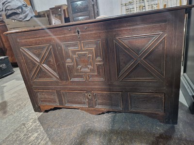 Lot 1354 - An oak mule chest with a carved panel front...