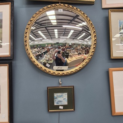 Lot 21 - A round gilt foliate framed convex mirror Ø 56cm