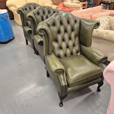 Lot 44 - A leather button back wing arm chair