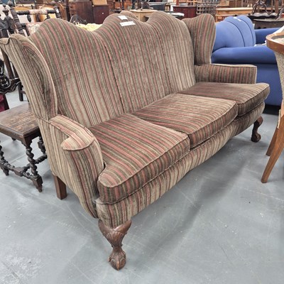 Lot 53 - An early 20th century camel back wing sofa...