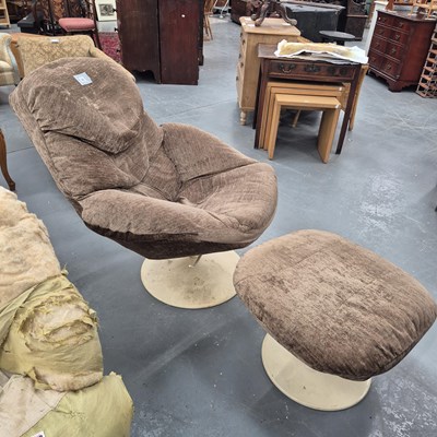 Lot 54 - A mid century swivel armchair and footstool,...