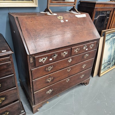 Lot 86 - A 19th century oak bureau of two over three...