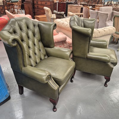 Lot 44A - Two leather button back wing arm chairs